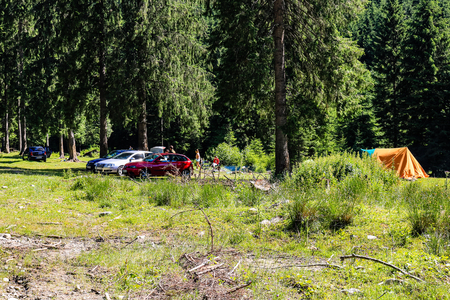 Iezer Mountains - Romania - 2019. People relaxing next to a river, and having barbeque.のeditorial素材