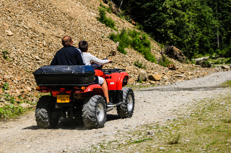 Iezer Mountains - Romania - 2019. Young people having a fun ride in the forest of Iezer Mountains on a ATV.のeditorial素材