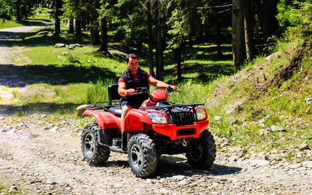 Iezer Mountains - Romania - 2019. Young people having a fun ride in the forest of Iezer Mountains on a ATV.のeditorial素材