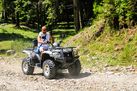 Iezer Mountains - Romania - 2019. Young people having a fun ride in the forest of Iezer Mountains on a ATV.のeditorial素材