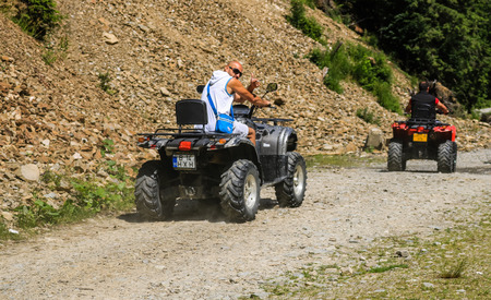Iezer Mountains - Romania - 2019. Young people having a fun ride in the forest of Iezer Mountains on a ATV.のeditorial素材