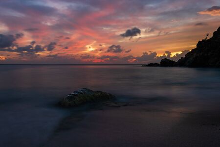 Travel photo of St. Barthâs Island (St. Bartâs Island), Caribbean. View of a peaceful sunset and waves on Shell Beach.の写真素材