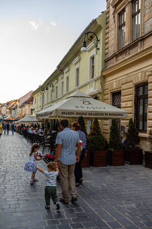 Brasov, Romania - 2019. Family with kids wandering on the streets of Brasov old town.のeditorial素材
