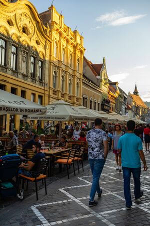 Brasov, Romania - 2019. People having dinner and wandering on the streets of Brasov old town.のeditorial素材