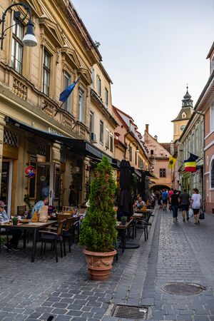 Brasov, Romania - 2019. People having dinner and wandering on the streets of Brasov old town.のeditorial素材
