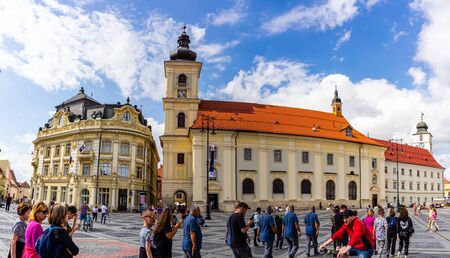 Sibiu, Romania - 2019. Tourist wondering in the panoramic The Big Square (Piata Mare) of Sibiu looking and the City hall.のeditorial素材