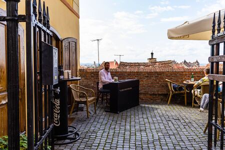 Sibiu, Romania - 2019. Young man playing piano at a local coffee shop in Sibiu.のeditorial素材