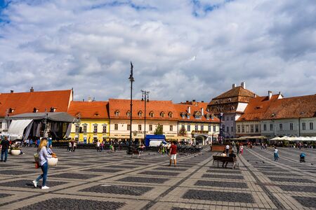 Sibiu, Romania - 2019. Tourist wondering in the panoramic The Big Square (Piata Mare) of Sibiu looking and the City hall.のeditorial素材