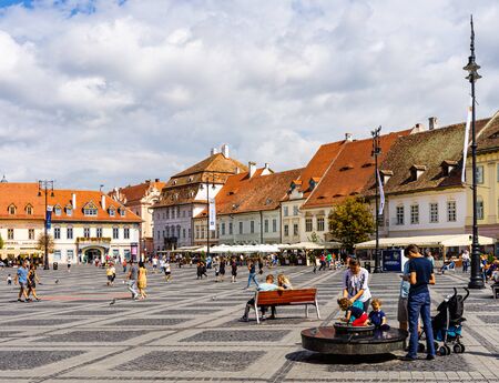 Sibiu, Romania - 2019. Tourist wondering in the panoramic The Big Square (Piata Mare) of Sibiu looking and the City hall.のeditorial素材