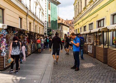 Sibiu, Romania - 2019. Tourists looking for souvenirs at local artisans shops in downtown Sibiu.のeditorial素材
