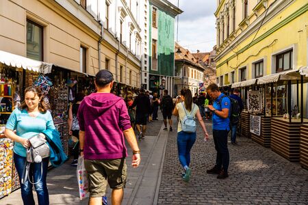 Sibiu, Romania - 2019. Tourists looking for souvenirs at local artisans shops in downtown Sibiu.のeditorial素材