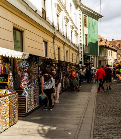 Sibiu, Romania - 2019. Tourists looking for souvenirs at local artisans shops in downtown Sibiu.のeditorial素材
