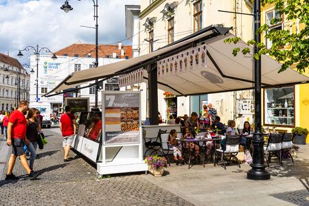 Sibiu, Romania - 2019. Young girls eating ice-cream at a local restaurant in downtown Sibiu.のeditorial素材