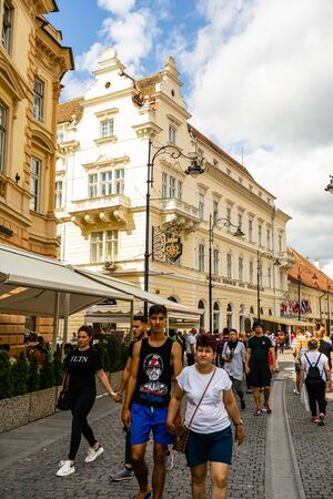 Sibiu, Romania - 2019. People and tourists having lunch and wandering on the streets of Sibiu old town.のeditorial素材