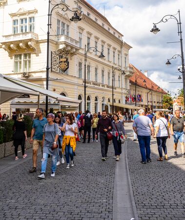 Sibiu, Romania - 2019. People and tourists having lunch and wandering on the streets of Sibiu old town.のeditorial素材