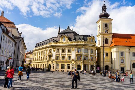 Sibiu, Romania - 2019. Tourist wondering in the panoramic The Big Square (Piata Mare) of Sibiu looking and the City hall.のeditorial素材