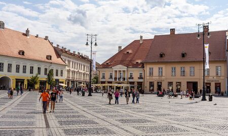 Sibiu, Romania - 2019. Tourist wondering in the panoramic The Big Square (Piata Mare) of Sibiu looking and the City hall.のeditorial素材