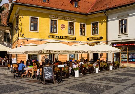 Sibiu, Romania - 2019. People and tourists having lunch and wandering on the streets of Sibiu old town.のeditorial素材