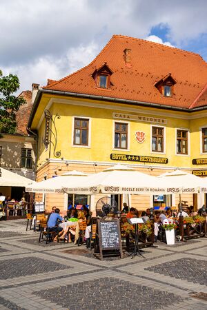 Sibiu, Romania - 2019. People and tourists having lunch and wandering on the streets of Sibiu old town.のeditorial素材
