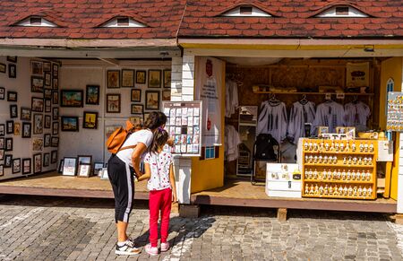Sibiu, Romania - 2019. Mom and daughter looking for souvenirs at local artisans shops in downtown Sibiu.のeditorial素材