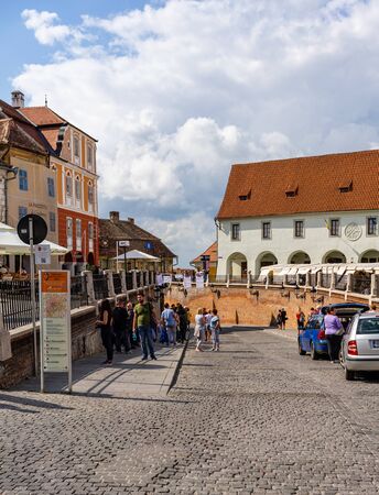 Sibiu, Romania - 2019. People wandering on the streets of Sibiu (old town). Streets with colorful houses.のeditorial素材