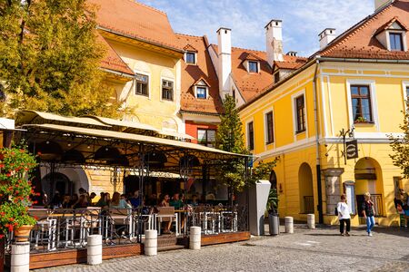 Sibiu, Romania - 2019. People and tourists having lunch and wandering on the streets of Sibiu old town.のeditorial素材