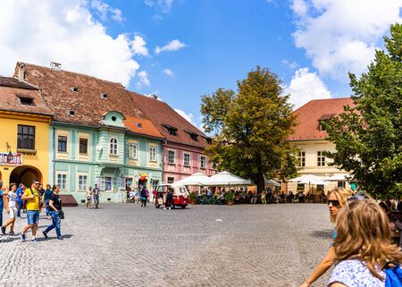 Sighisoara, Romania - 2019. People wandering on the streets of Sighisoara citadel (old town). Streets with colorful houses.のeditorial素材