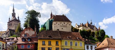 Sighisoara, Romania - 2019. Beautiful view of colorful houses and Tower Clock (Turnul cu ceas) in Sighisoara citadel.のeditorial素材