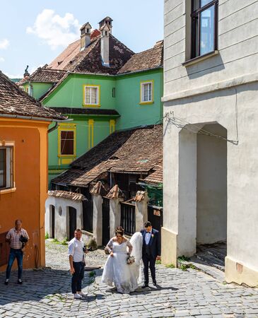 Sighisoara, Romania â 2019.    Happy newly married couple preparing to take a picture.のeditorial素材