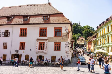 Sighisoara, Romania - 2019. People having lunch and wandering on the streets of Sighisoara old town.のeditorial素材