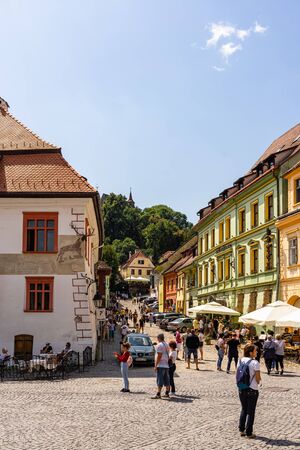 Sighisoara, Romania - 2019. People wandering on the streets of Sighisoara citadel (old town). Streets with colorful houses.のeditorial素材