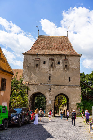 Sighisoara, Romania - 2019. People wandering on the streets of Sighisoara citadel (old town). Streets with colorful houses.のeditorial素材
