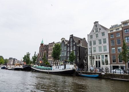 Amesterdam, Holland â 2019. Amsterdam Houseboats on the banks of the Amstel River.のeditorial素材