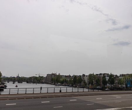 Amesterdam, Holland â 2019. Cityscape on a grey weather. View of the bridge and canal in the historic center of Amsterdam.のeditorial素材