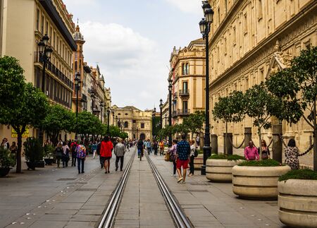 Seville, Spain â 2019. People walking down a street in the old city. Seville is the capital of Andalusia.のeditorial素材
