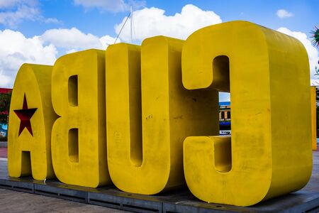 Santiago de Cuba, Cuba â 2019. Big Yellow Cuba Sign on Santiago Waterfront.のeditorial素材