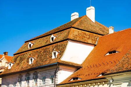 Medieval house in Sibiu with old roof tiles and old paint.の写真素材