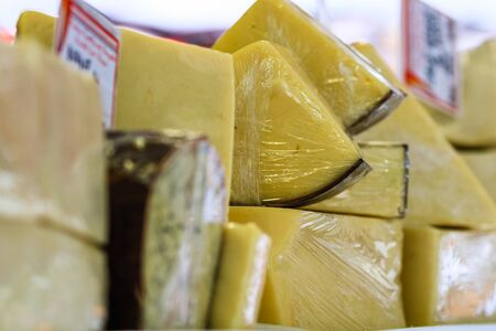 Close up photo of cheese ready for sale at a local street foot festivalの写真素材