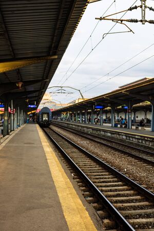 Travelers waiting for a train, on the platform of Bucharest North Railway Station (Gara de Nord) in Bucharest, Romania, 2019の写真素材