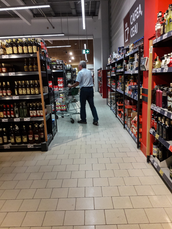 Sale, consumerism and people shopping concept - shopping cart at grocery store or supermarket in Bucharest, Romania, 2019のeditorial素材