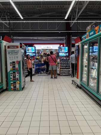 Sale, consumerism and people shopping concept - shopping cart at grocery store or supermarket in Bucharest, Romania, 2019のeditorial素材