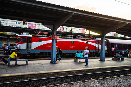 Travelers waiting for a train, sitting on a bench on the platform of Bucharest North Railway Station (Gara de Nord) in Bucharest, Romania, 2019のeditorial素材