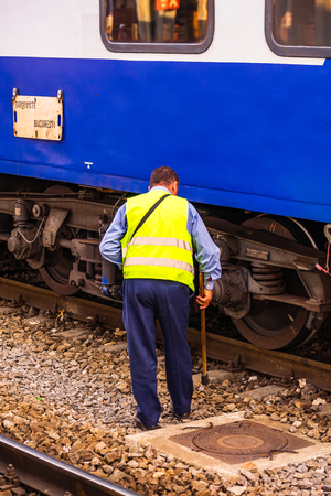 Train crew doing the last checking on the train platform at the railway station of Bucharest North Railway Station (Gara de Nord) in Bucharest, Romania, 2019のeditorial素材