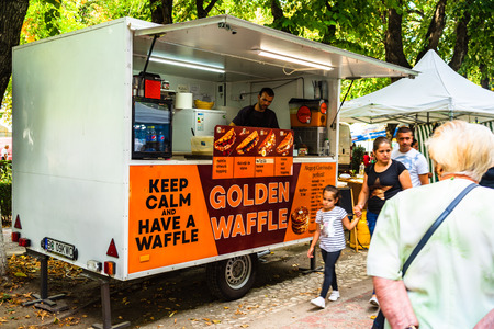 Man making waffles in a waffles truck at the artisans and flea market in Bucharest, Romania â 2019のeditorial素材