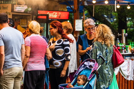 People waiting in line to buy meat on the grill, pork steaks, chicken breast, sausages, pieces of meat chops at a food festival in Bucharest, Romania â 2019のeditorial素材