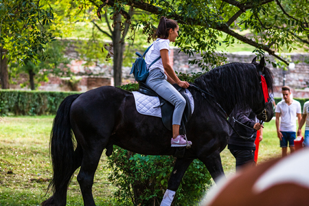Young girl horseback riding in a park in Targoviste, Romania, 2019のeditorial素材