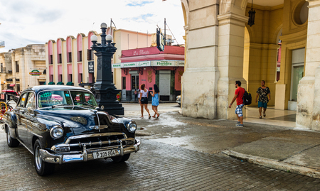 Havana, Cuba â 2019. Old American classic car parked in front of Floridita restaurant in Havana.のeditorial素材