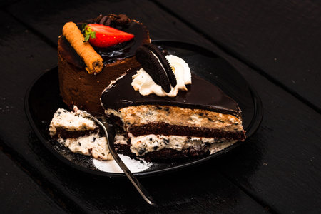 Chocolate mousse with strawberry, chocolate stick and creamy cheesecake with chocolate cookies...