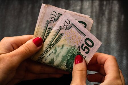 Woman counting money, counting dollars close upの写真素材