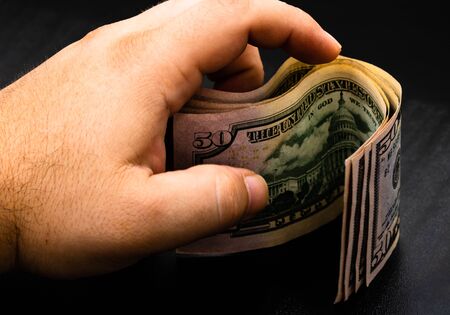 Man counting money, counting dollars close upの写真素材